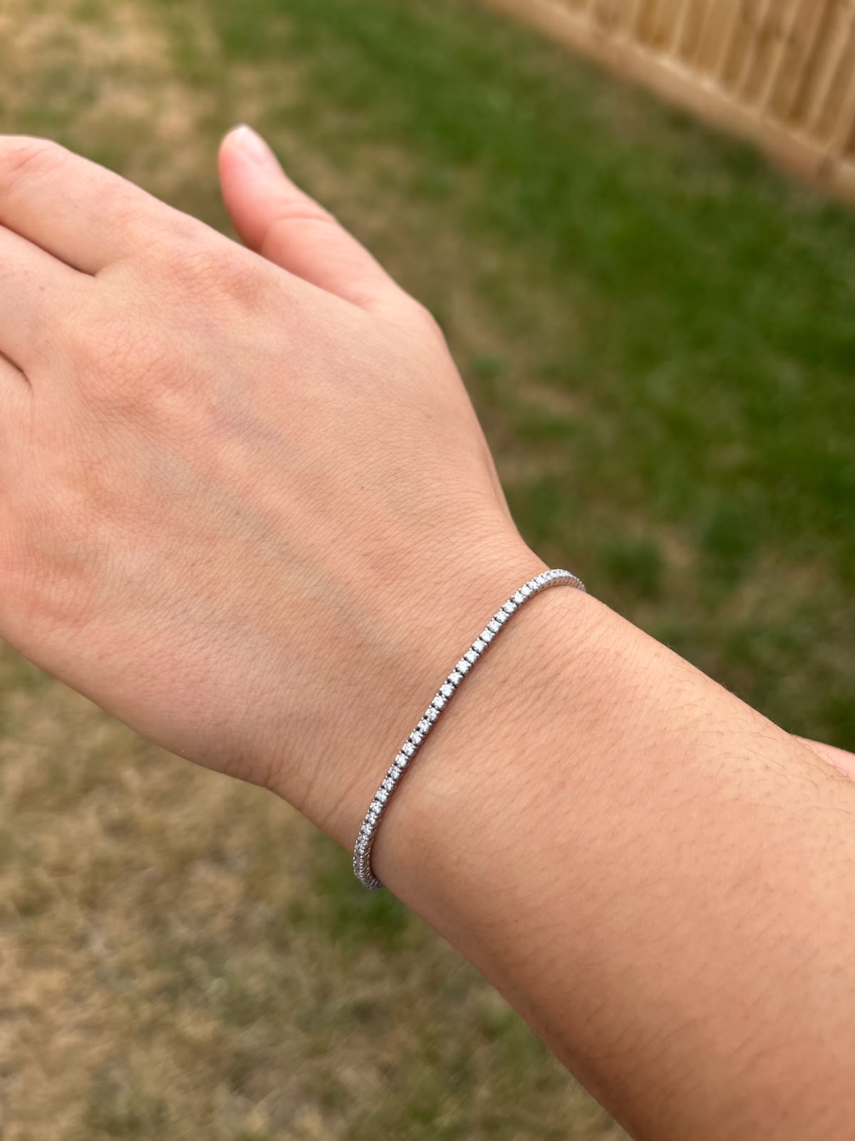 2ct diamond tennis bracelet set in platinum worn on the wrist